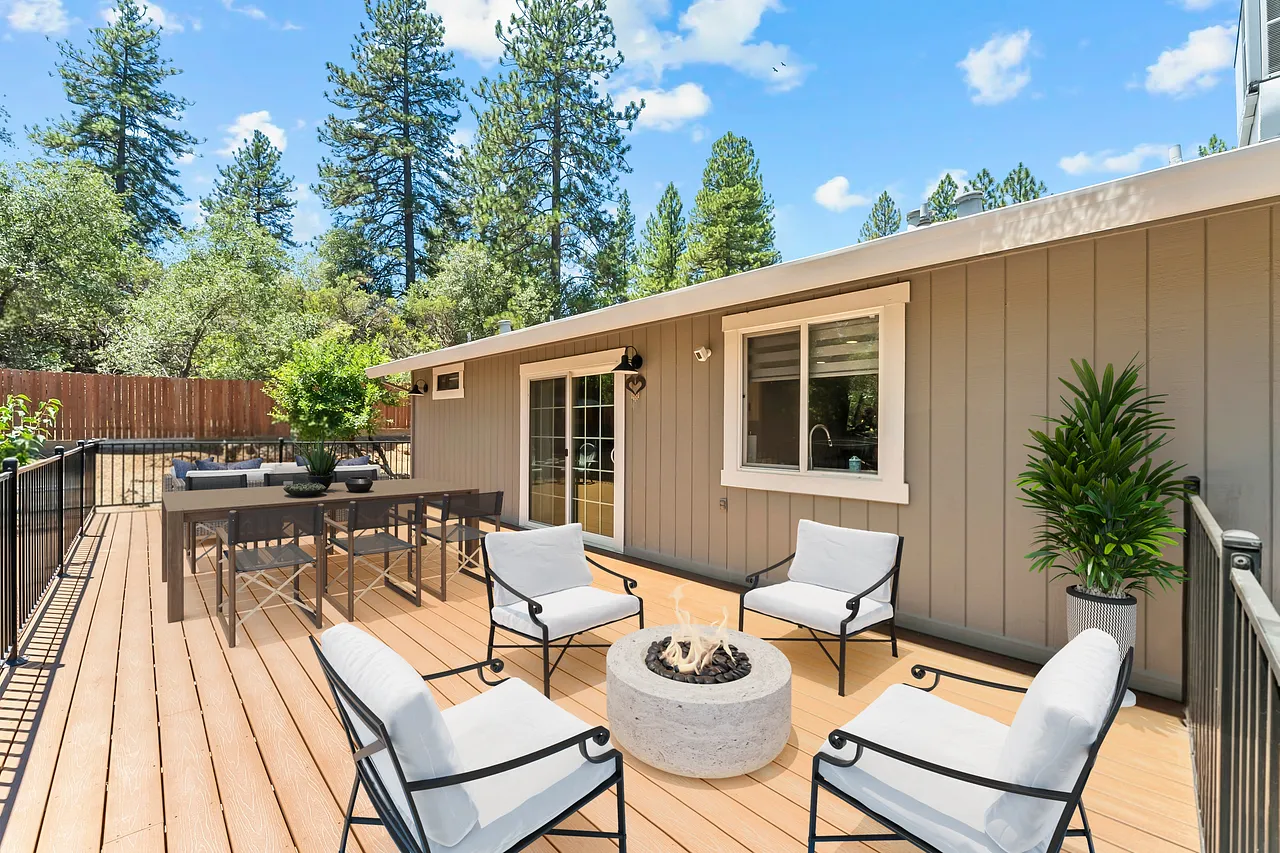 Furnished deck overlooking the wooded one-acre grounds